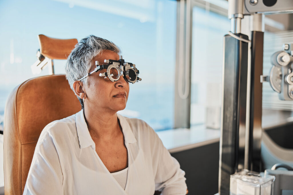 Patient undergoing a vision test during an eye exam, featuring optometric equipment and modern clinic ambiance.