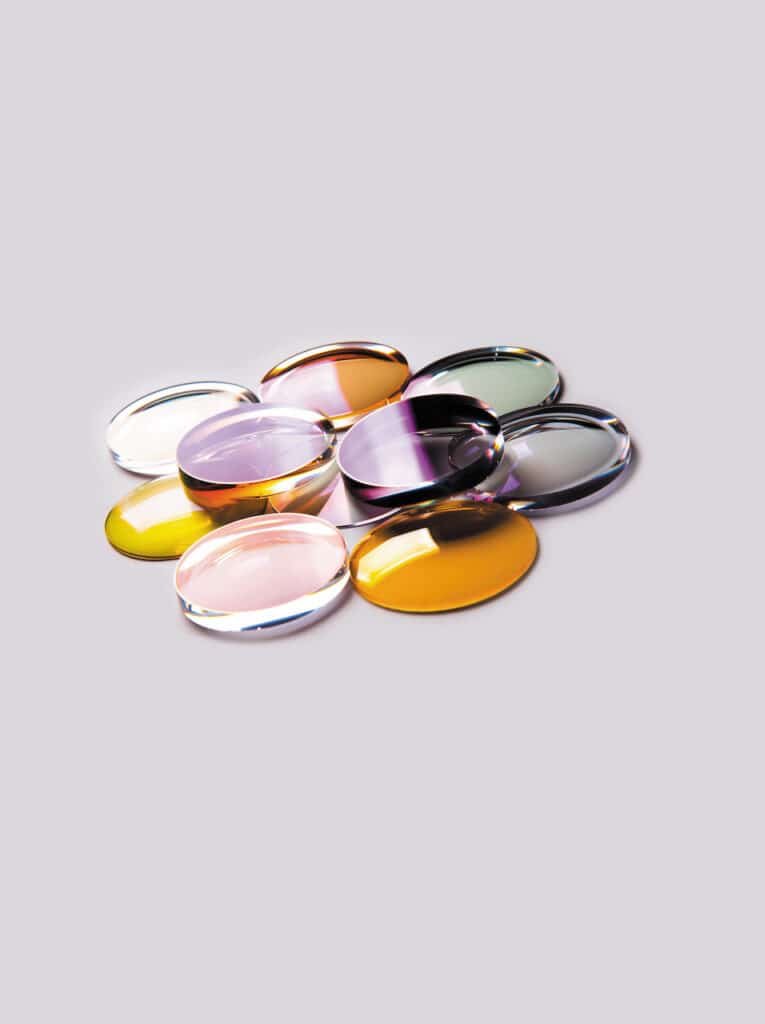 Photograph of about 9 circular, different-coloured tinted lenses arranged in a pattern.