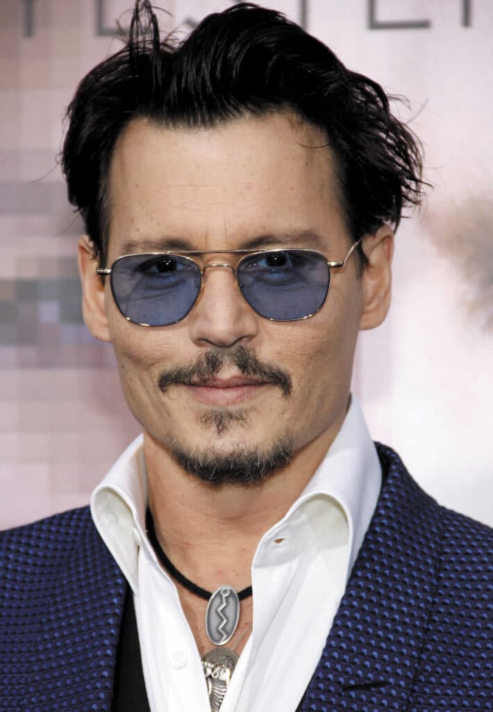 Photograph of Johnny Depp wearing aviators frames with blue tinted lenses.